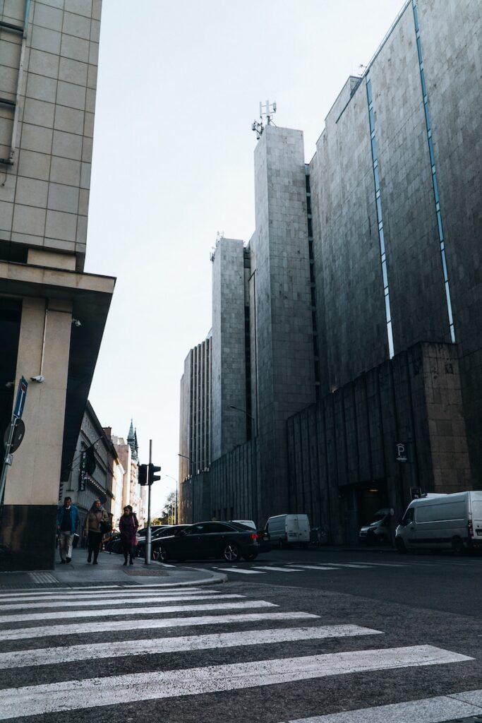 a city street with people crossing the street